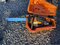 Poulan Pro chainsaw inside orange carry case with blue bar scabbard attached