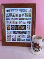 Framed stamp collection beside Sadler mug
