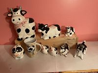 Group shot of eight cow-themed ceramic items