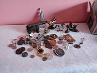 Full lot overview showing cannons, figurines, keychains and scattered coins