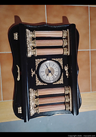 Full view of black and gold ornate wall clock