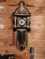 Full front view of clock with faux weights and pendulum
