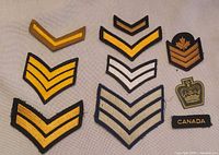 All ten assorted vintage Canadian military patches laid out on fabric background