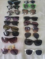 Full group of 18 sunglasses laid out in two columns