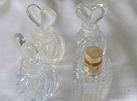 Three ribbed heart-stopper bottles and one Valentino bottle grouped together
