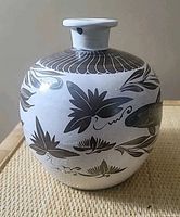 Front view of vase showing koi and lotus motifs