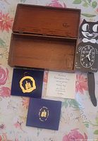 All three items: open Cedarap wooden box, cat clock face and tail, ornament box and pamphlet