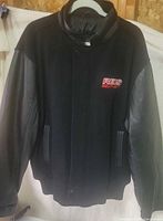 Front view showing wool body, leather sleeves, chest logo