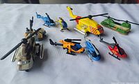 Group view of nine die-cast helicopters on white background