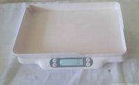 Top view of white digital scale with empty tray