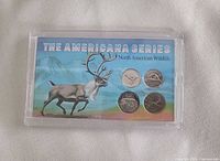 Front of sealed coin set showing four Canadian coins and illustrated card