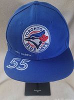 Front view showing embroidered logo, printed name and number on visor