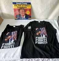 Front view of both T-shirts and calendar