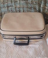 Top view of off-white Samsonite suitcase showing exterior condition