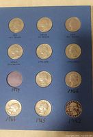 Page of folder with coins showing individual years and vacant slots
