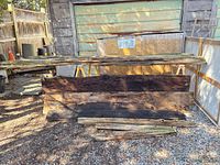 Front view of cedar rails and barn boards leaning against structure