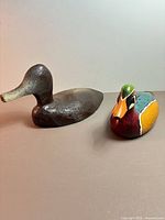 Both wooden duck decoys side by side