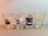 Front view of all four Led Zeppelin pint glasses showing distinct graphics