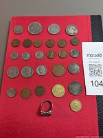 All 27 coins laid out plus ring