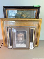 All four framed prints standing together to show relative sizes, frame finishes and subjects