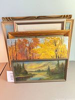 Front view showing stack of framed paintings