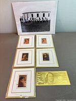 overview of all items laid out: five miniature prints, gold foil bill, large photo