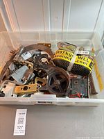 Overview of bin showing pulley, strap, assorted hardware