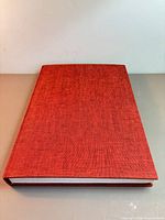 Front view of red cloth-bound hardcover book
