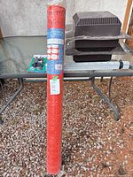 Full lot view showing safety fence roll, packaged latch, roof vents, and perforated straps