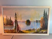 Full view of framed oil painting showing landscape scene