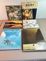 Six hardcover books arranged on table showing covers