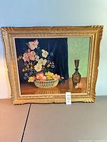 Front view of framed oil on board floral still life painting