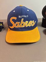 Front view of Buffalo Sabres hat showing embroidery and color scheme
