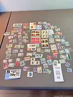 Full layout of assorted stamps spread on table