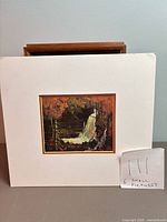 Matted waterfall reproduction print with note indicating 6 pictures