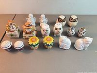 Group photo showing all 16 ceramic/porcelain salt and pepper shakers arranged in two rows