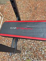 Close-up of CAP Strength branded padded bench
