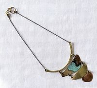Full view of necklace showing chain, clasp, bar, and three panels