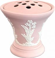 Side view of pink vase showing white relief