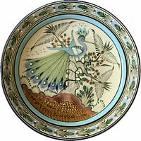 Front view of Ken Edwards ceramic plate with peacock design