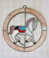 Front view of circular stained glass pony ornament