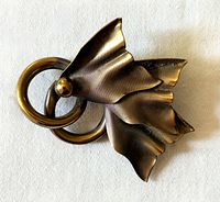 Front view of brooch showing leaf motif and rings