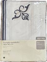 Front of packaged Coincasa embroidered cotton tablecloth showing brand label and embroidery design