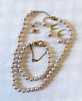 Necklace, bracelet, both earring pairs displayed
