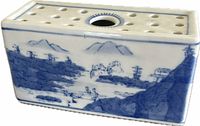 front view of rectangular blue and white pierced flower brick vase