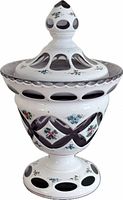 Full view of lidded purple and white overlay glass jar showing cut windows and floral enamels