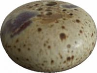 Top view showing large and small holes, speckled glaze