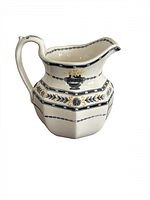 Full view of cream ceramic pitcher with black laurel band and urn motif