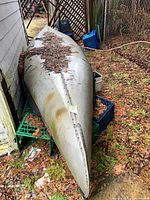 Full view of upside-down aluminum canoe showing length and keel