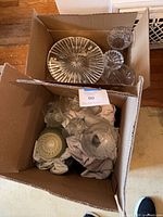 Two boxes containing assorted clear and green glassware